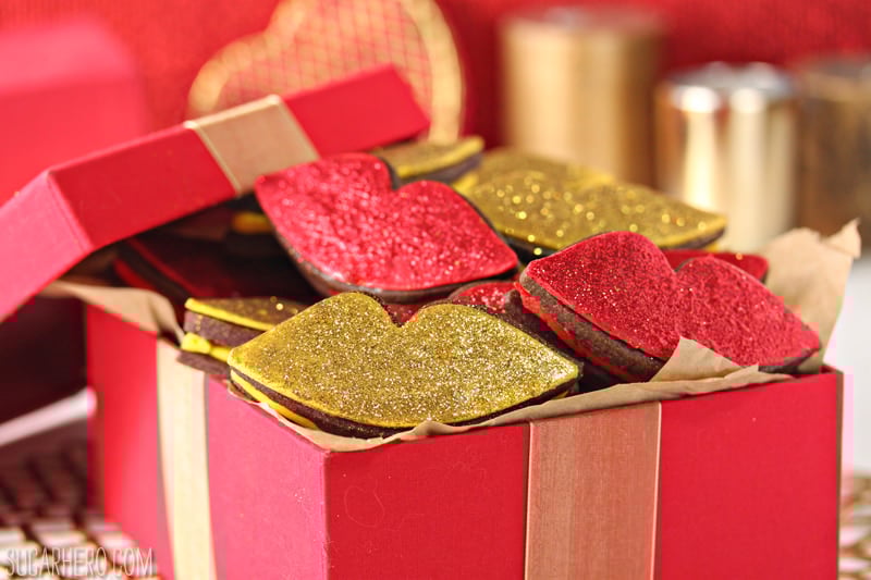 Red Hot Love Cookies | From SugarHero.com Red Hot Love Cookies - rich chocolate cookies sandwiching a spicy cinnamon buttercream, and finished with gorgeous glittery decorations! | From SugarHero,com
