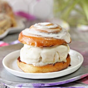 Close up of a Cinnamon Roll Ice Cream Sandwich on a small white plate.