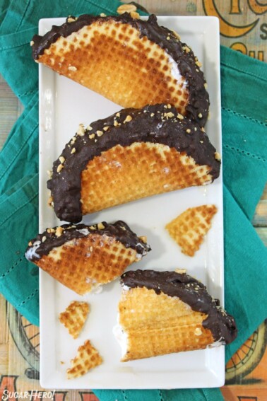 Overhead shot of three homemade choco tacos on a white platter