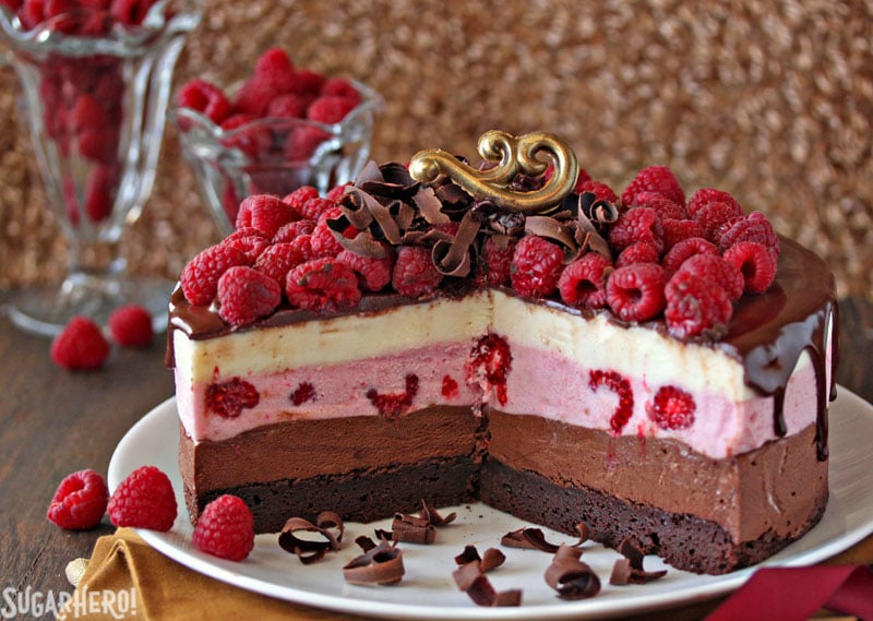 Chocolate Raspberry Mousse Cake - Mousse cake with pieces taken out, showing the inside and layers. | From SugarHero.com