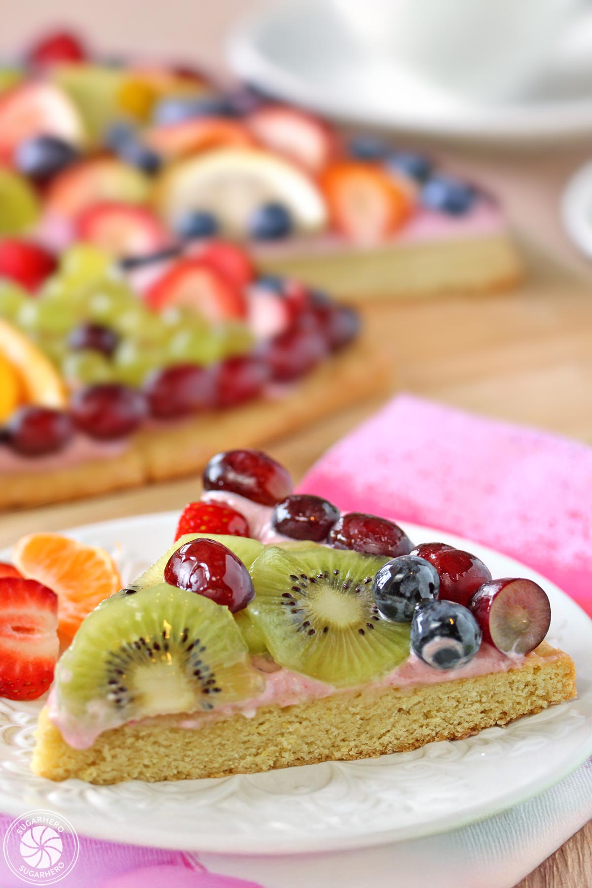 Slice of Easter Egg Fruit Pizza on a white embossed plate