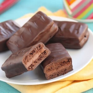 Stack of Homemade Tim Tams on a plate with bites removed to show layers.
