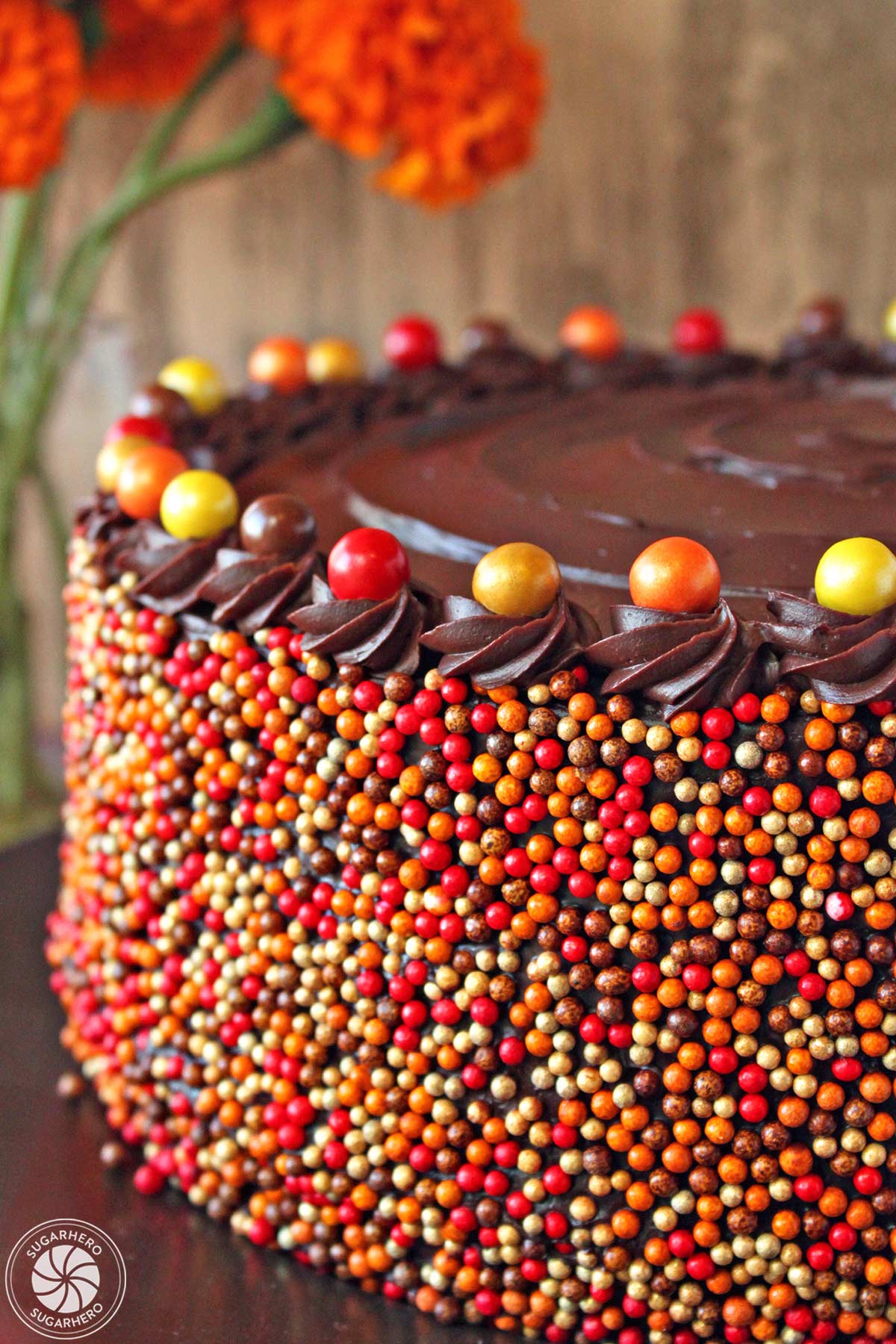 Side view of a Pumpkin Layer Cake covered in sprinkles.