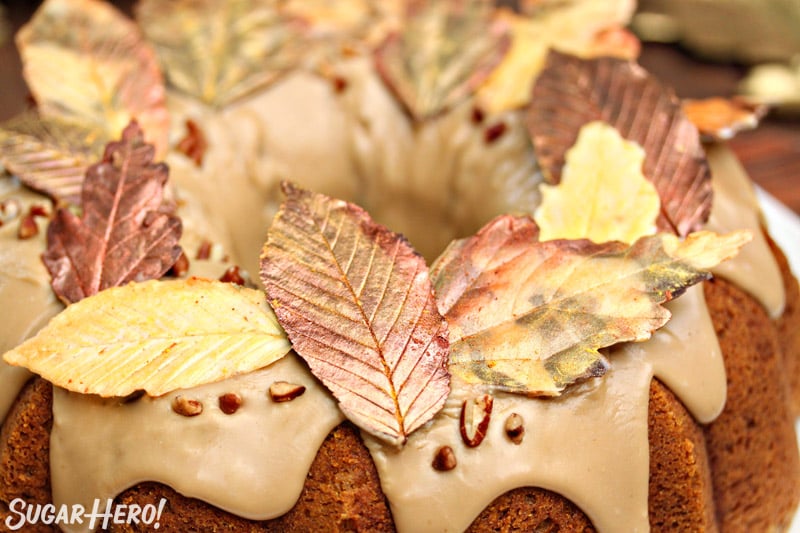 Close-up of gold-dusted chocolate leaves on top of Pumpkin Pound Cake.