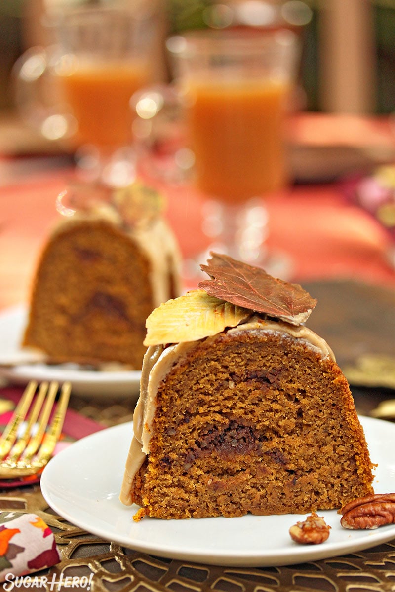 Slice of Pumpkin Pound Cake on a small white plate with chocolate leaves on top.