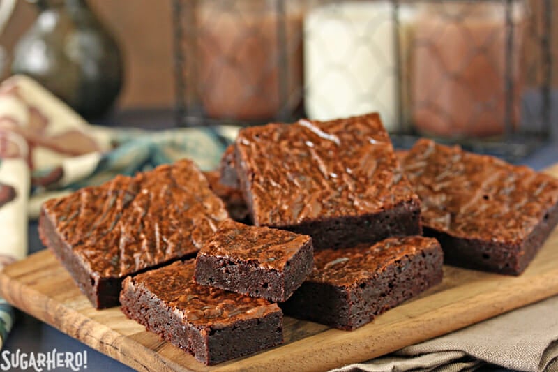 Ultimate Fudgy Chocolate Brownies - brownies stacked up on a plate | From SugarHero.com