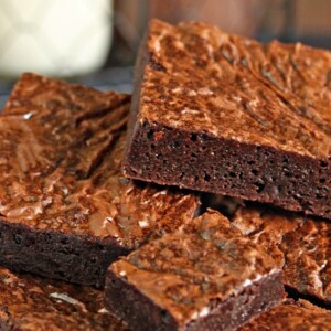 Close up of a pile of square cut Ultimate Fudgy Chocolate Brownies.