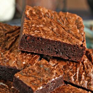 Close up of a pile of square cut Ultimate Fudgy Chocolate Brownies.
