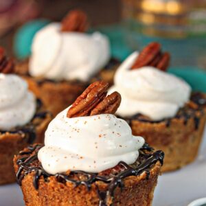Close up of Mini Pecan Pie with whipped cream on top.