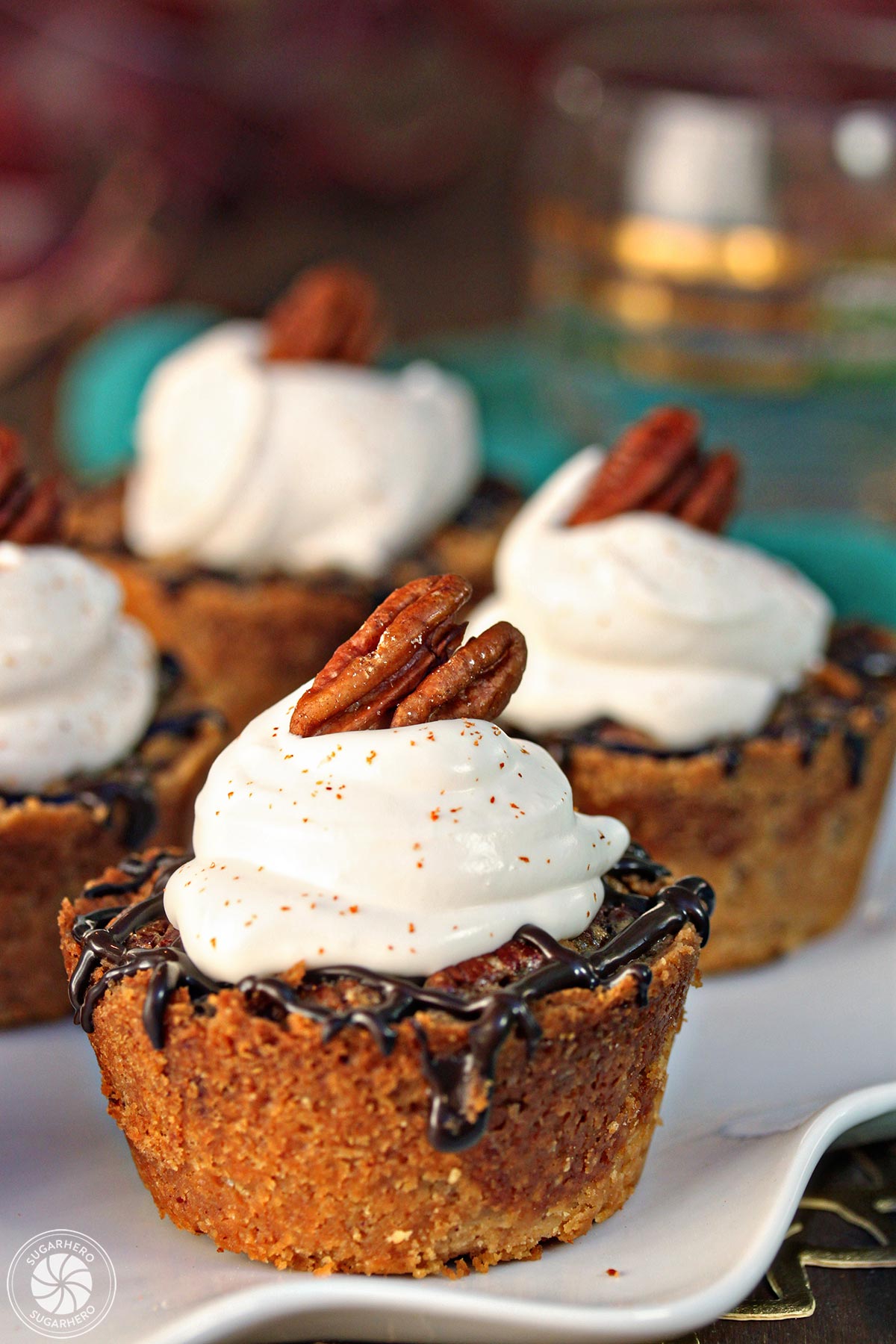 Mini Pecan Pies - cute bite-sized tarts with pecan tart dough, lots of pecans, and a bit of chocolate! | From SugarHero.com Mini Pecan Pies | From SugarHero.com