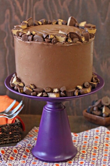 Peanut Butter Cup Banana Cake on a purple cake stand.
