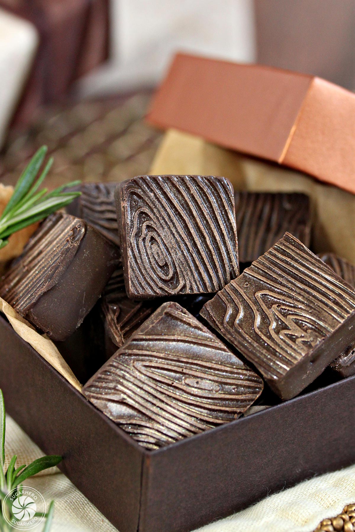 Rosemary Raspberry Truffles - box of square chocolate truffles with wood grain pattern | From SugarHero.com