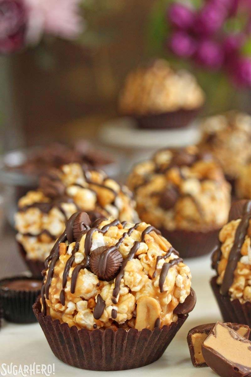 Peanut Butter Cup Popcorn Balls - sweet, chewy popcorn balls packed with chocolate peanut butter cups! | From SugarHero.com