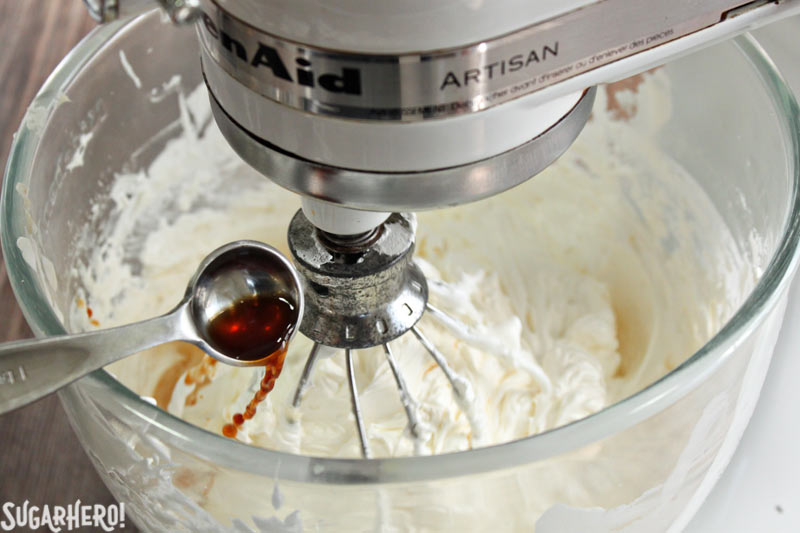 How to Make Swiss Meringue Buttercream - A photo of the vanilla being added.  | From SugarHero.com