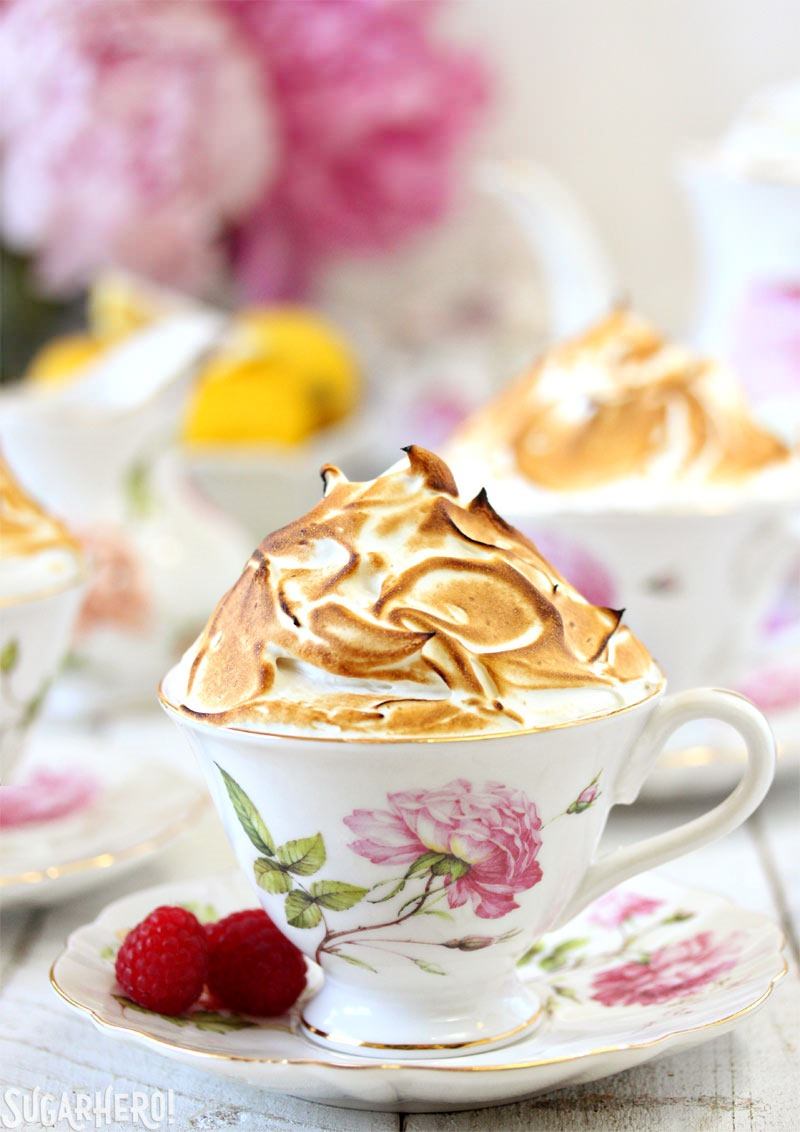 Lemon Meringue Teacup Cakes -lemon cupcakes baked right in teacups! Filled with raspberry jam and lemon curd, and topped with a big pile of toasted meringue. | From SugarHero.com Lemon Meringue Teacup Cakes | From SugarHero.com