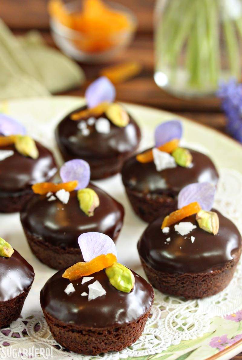 Nougat-Stuffed Brownie Bites - moist brownies filled with honey nougat and topped with a shiny chocolate glaze. They're elegant and addicting! | From SugarHero.com Nougat-Stuffed Brownie Bites | From SugarHero.com