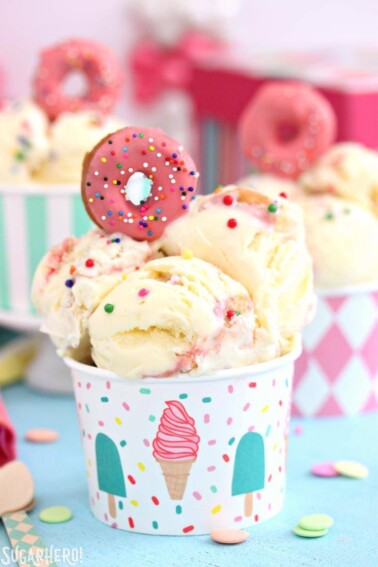 Several scoops of Doughnut Funfetti Ice Cream in a colorful cup.