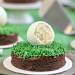 Close up of a Golf Ball Truffle and Putting Green Brownie with a bite removed from the truffle to show the interior.