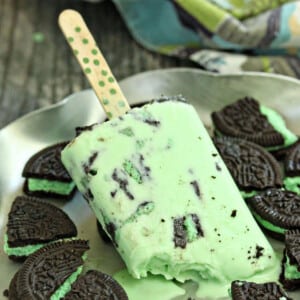 White Chocolate Mint Cookie Popsicle melting into a plate full of Mint Oreos.