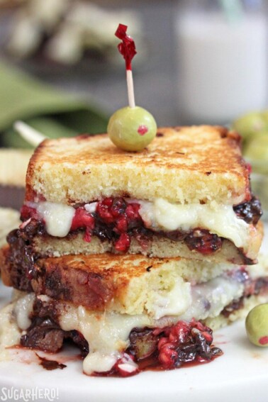 Close up of a Dessert Grilled Cheese Sandwich showing the layers of cheese, chocolate and raspberries.