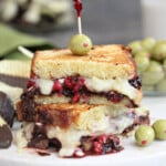 Close up of a Dessert Grilled Cheese Sandwich with melty cheese and olive on top.