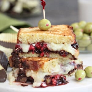 Close up of a Dessert Grilled Cheese Sandwich with melty cheese and olive on top.