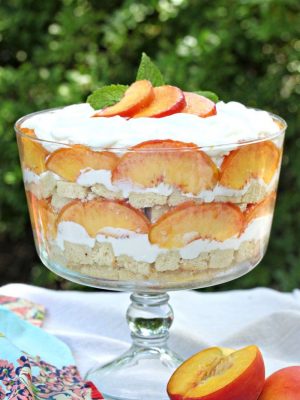 Close up of Peaches and Cream Trifle in a clear trifle bowl.