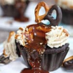 Chocolate-Dipped Pretzel Cupcake on a white plate with caramel drizzling down the front.