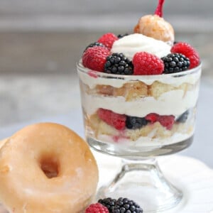 Close up of a Doughnut Trifle next to a large glazed doughnut.