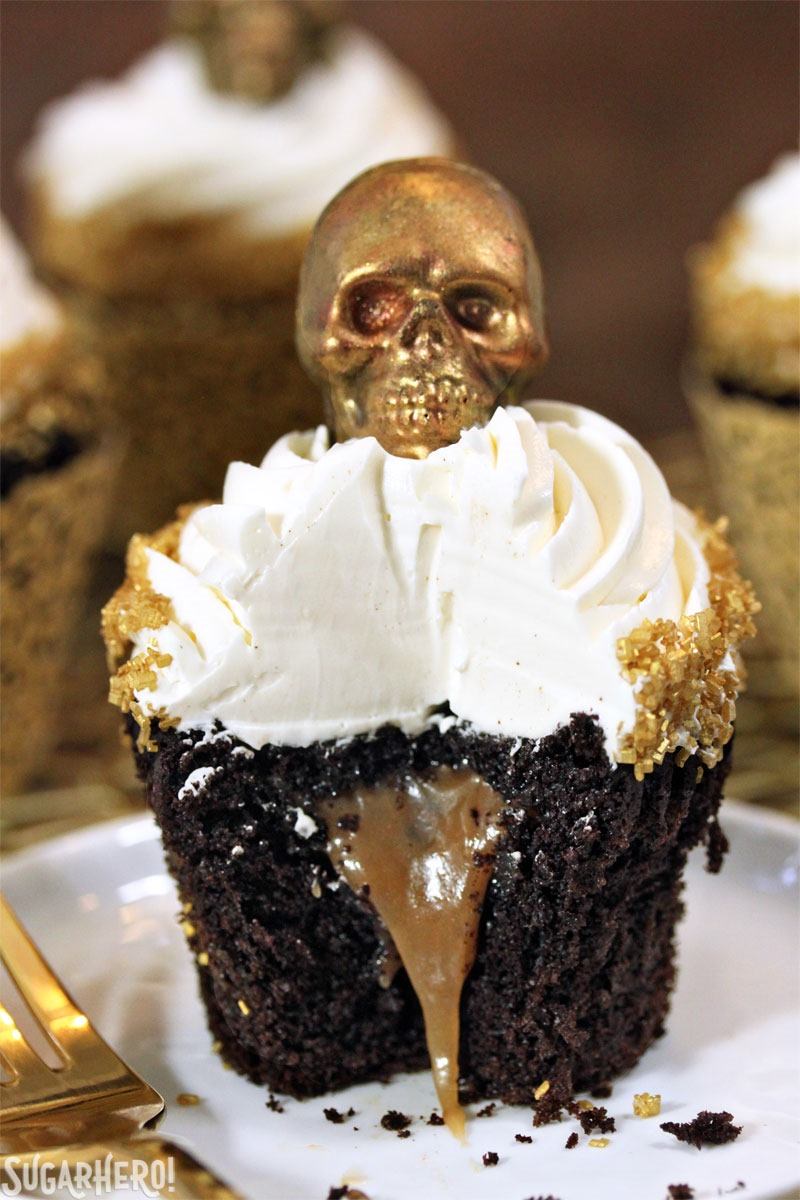 Caramel-Stuffed Chocolate Cupcakes with Caramel Skulls | From SugarHero.com