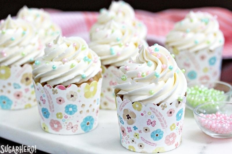 This is the Easiest Swiss Meringue Buttercream recipe you’ll ever make! Once you try it, you’ll want to use it to cover all of your cakes and cupcakes. | From SugarHero.com The Easiest Swiss Meringue Buttercream - A close up shot of cupcakes with piped buttercream. | From SugarHero.com
