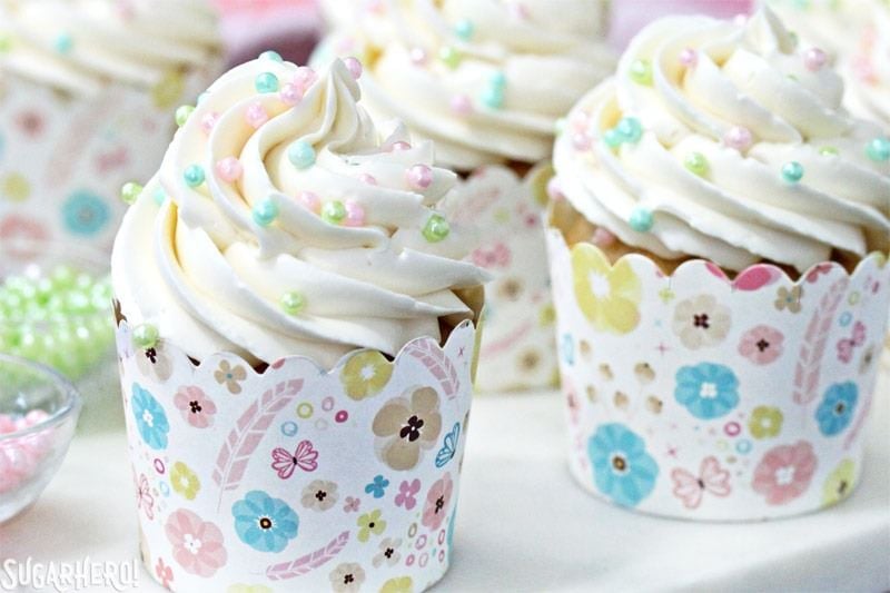 The Easiest Swiss Meringue Buttercream - A close up shot of a cupcake with piped buttercream. | From SugarHero.com