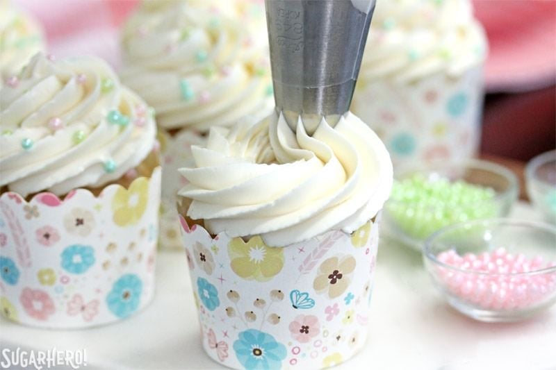 The Easiest Swiss Meringue Buttercream - A picture displaying the buttercream being piped. | From SugarHero.com
