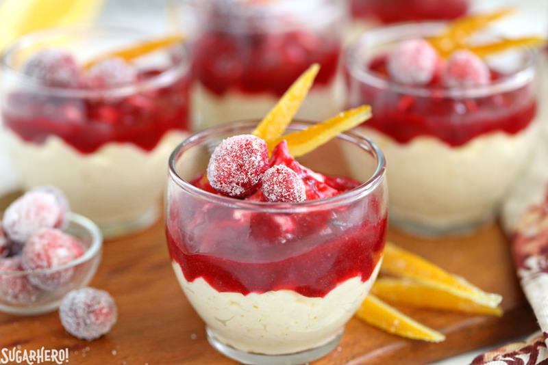 Orange Mousse with Cranberry Sauce - A straight shot of the mousse cups with orange slices. | From SugarHero.com