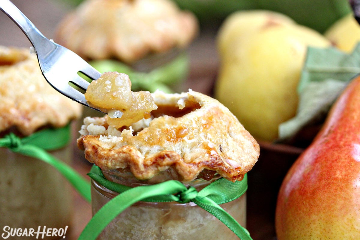 Close up of a Pear Pie in a Jar with a fork lifting out a bite.