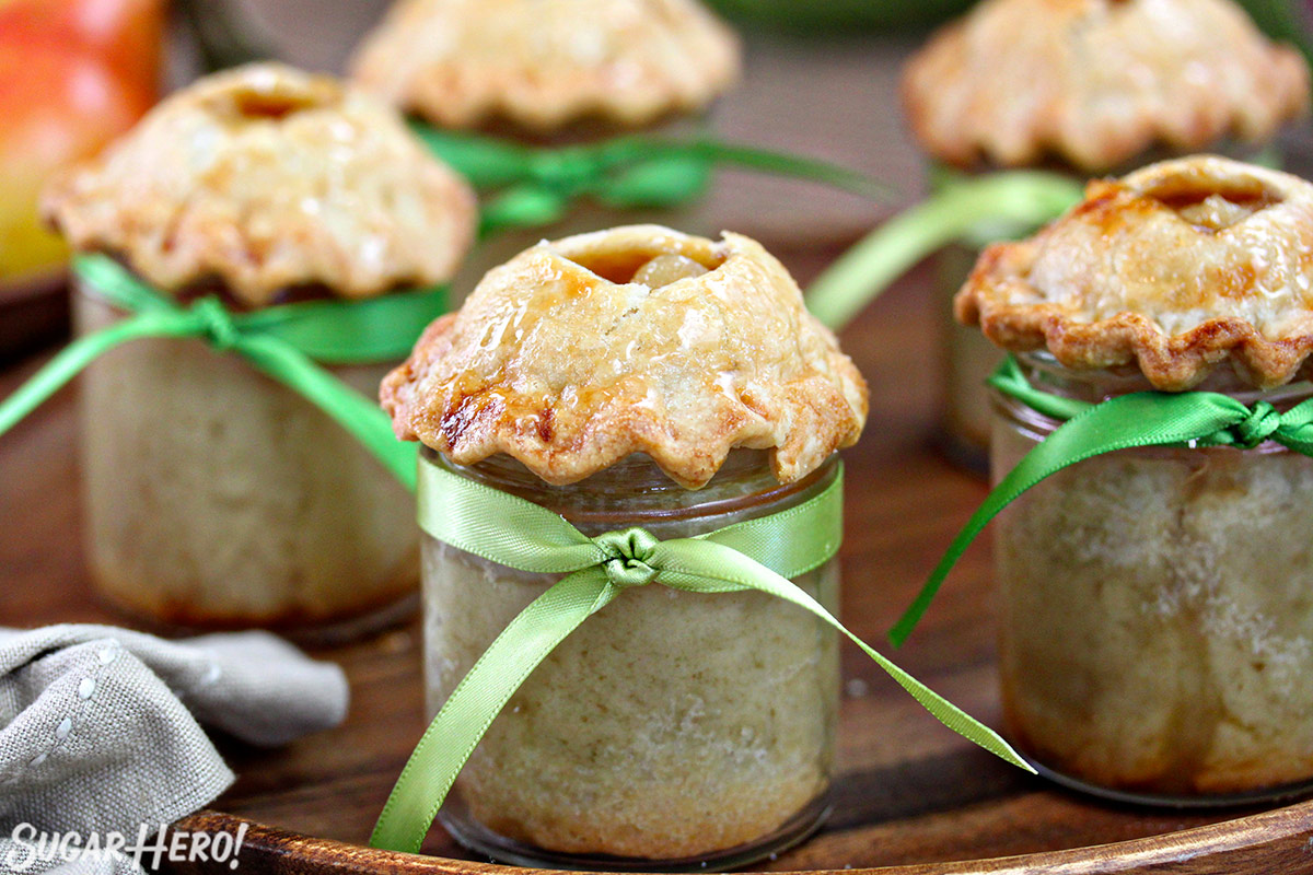 Assortment of Pear Pies In A Jar on a wooden surface.