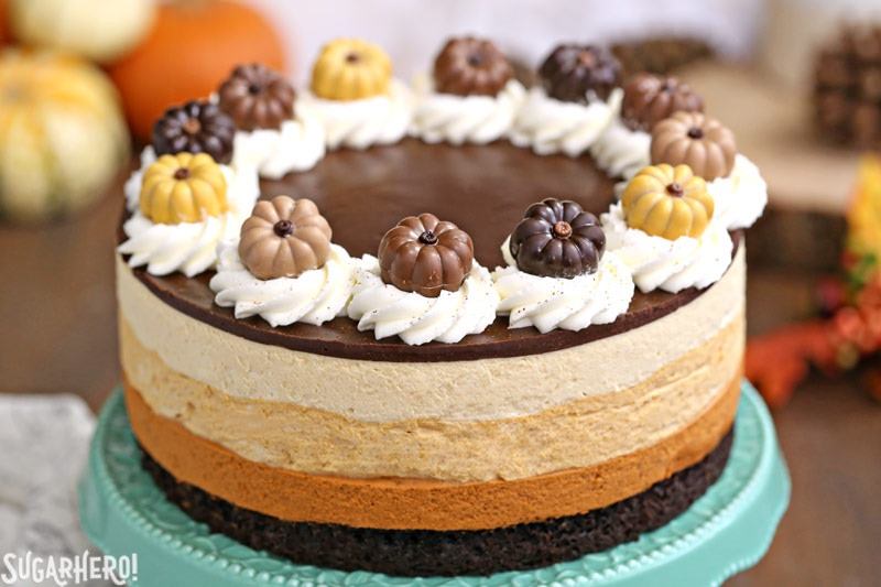 Pumpkin Chocolate Mousse Cake - A closer shot of the cake with cute pumpkin toppers. | From SugarHero.com