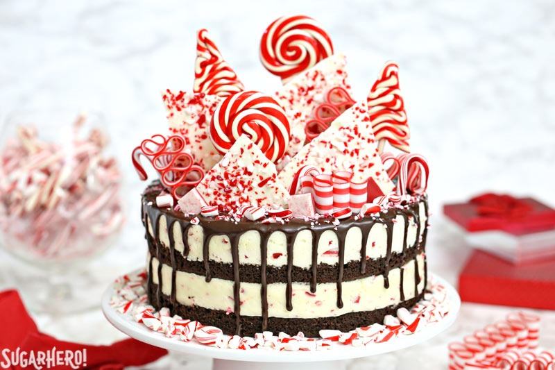 Candy Cane Mousse Cake on white cake stand with red linens around it