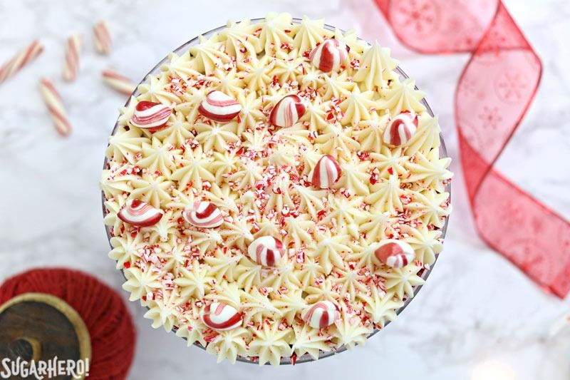Top view of Red Velvet Trifle showing the piped cream cheese frosting with peppermint pieces scattered on top