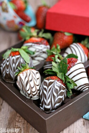 A brown box of Chocolate-Covered Strawberries with zig-zags and swirls.