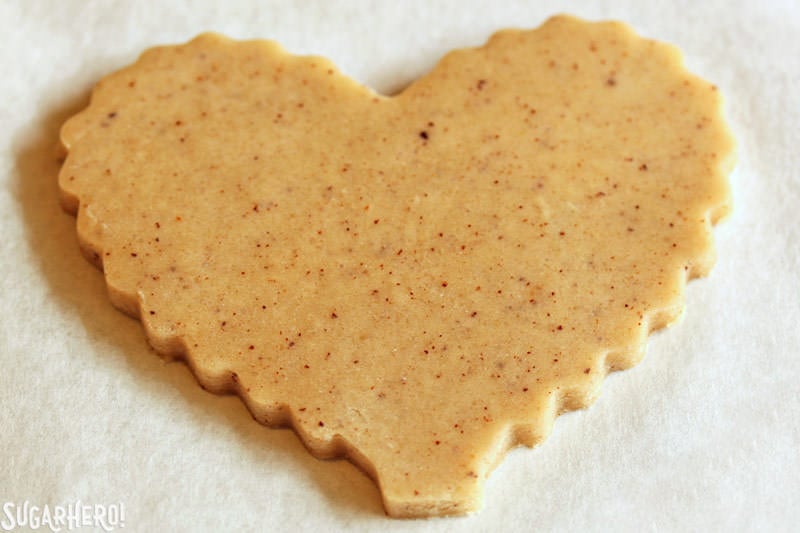 Brown Butter Heart Cookies - brown butter sugar cookies with pretty patterns for Valentine's Day! | From SugarHero.com Brown Butter Heart Cookies - close-up on a cut-out cookie ready to be baked | From SugarHero.com