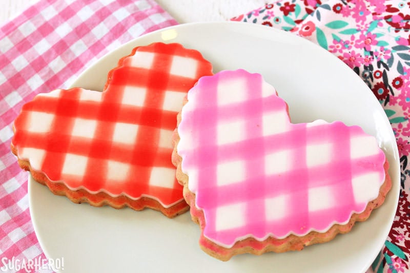 Brown Butter Heart Cookies - brown butter sugar cookies for Valentine's Day | From SugarHero.com Brown Butter Heart Cookies - two cookies with gingham fondant plaques on top | From SugarHero.com