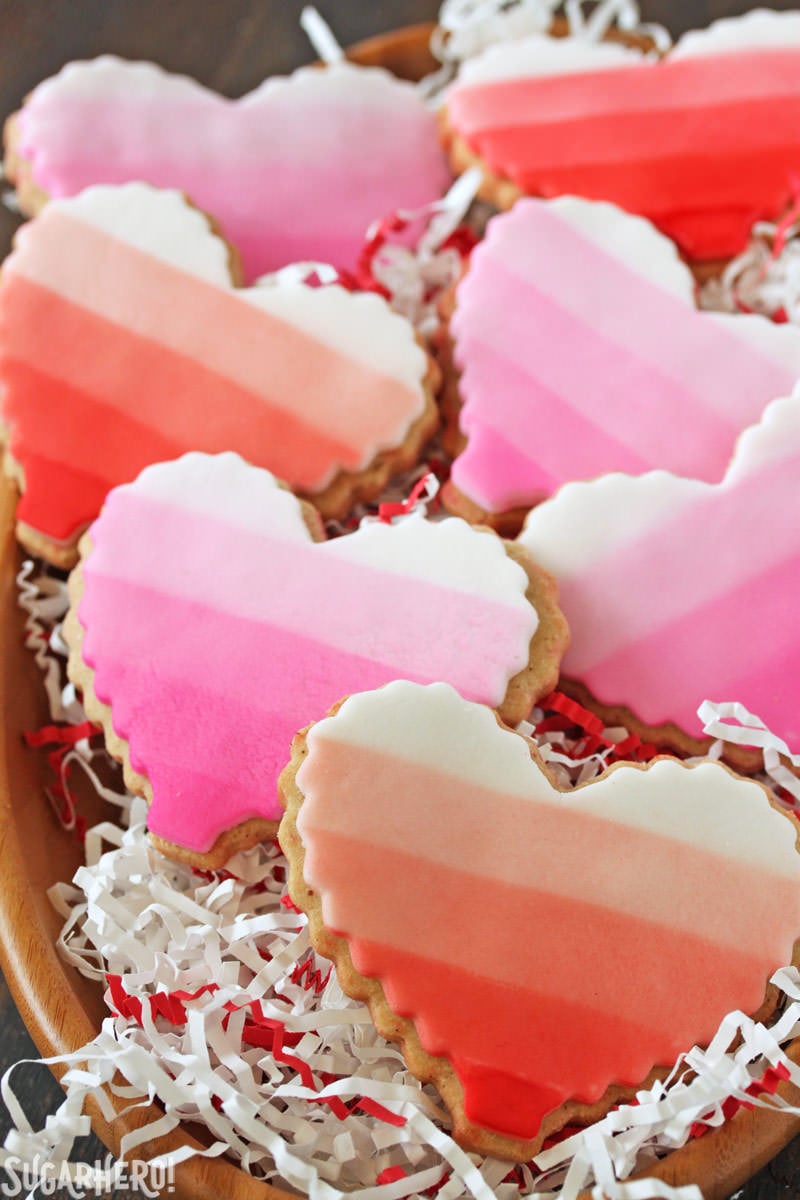 Brown Butter Heart Cookies - brown butter sugar cookies for Valentine's Day | From SugarHero.com Brown Butter Heart Cookies - ombre cookies stacked in a bowl with festive paper | From SugarHero.com