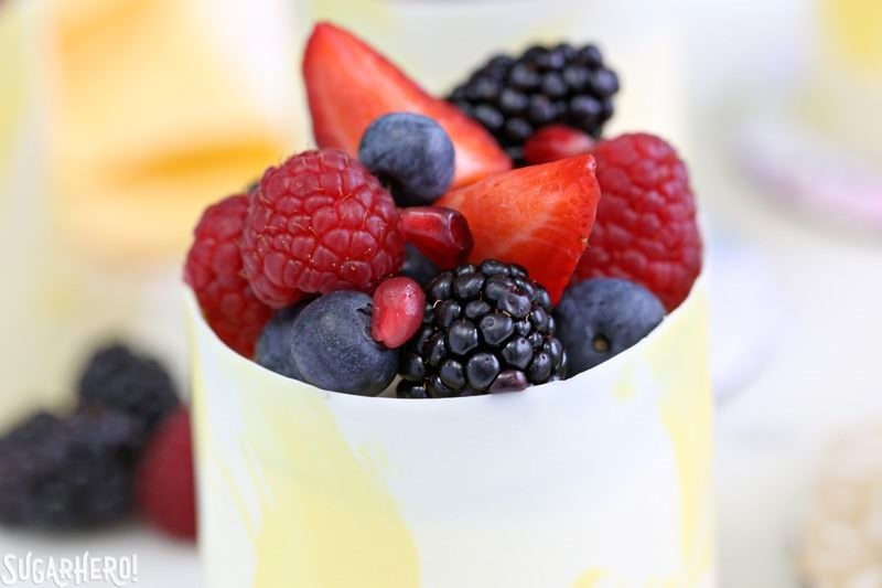 Lemon Mousse Cakes in White Chocolate Shells - lemon mousse in gorgeous painted white chocolate shells! | From SugarHero.com