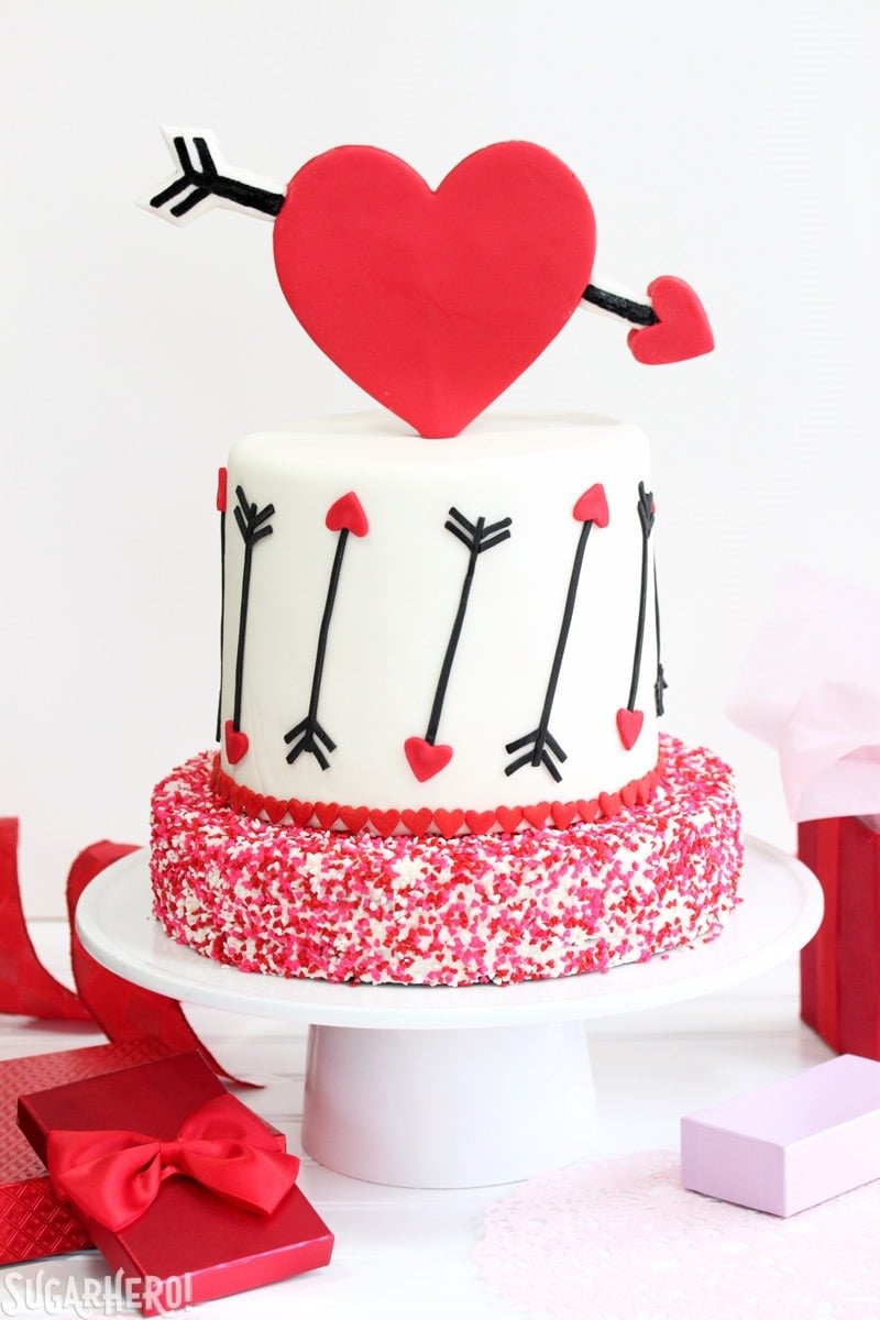 Pink and Red Velvet Valentine’s Day Cake - a pink and red velvet cake with a heart and arrow design for Valentine's Day! | From SugarHero.com