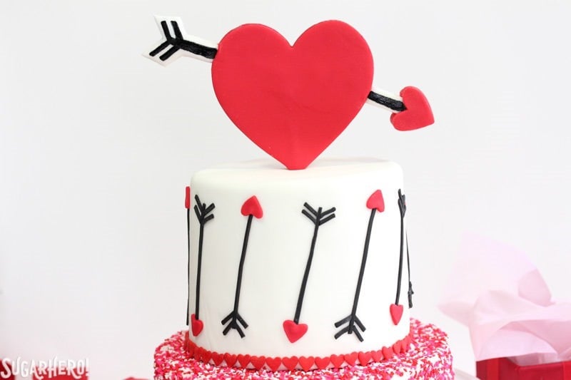 Pink and Red Velvet Valentine’s Day Cake - a pink and red velvet cake with a heart and arrow design for Valentine's Day! | From SugarHero.com