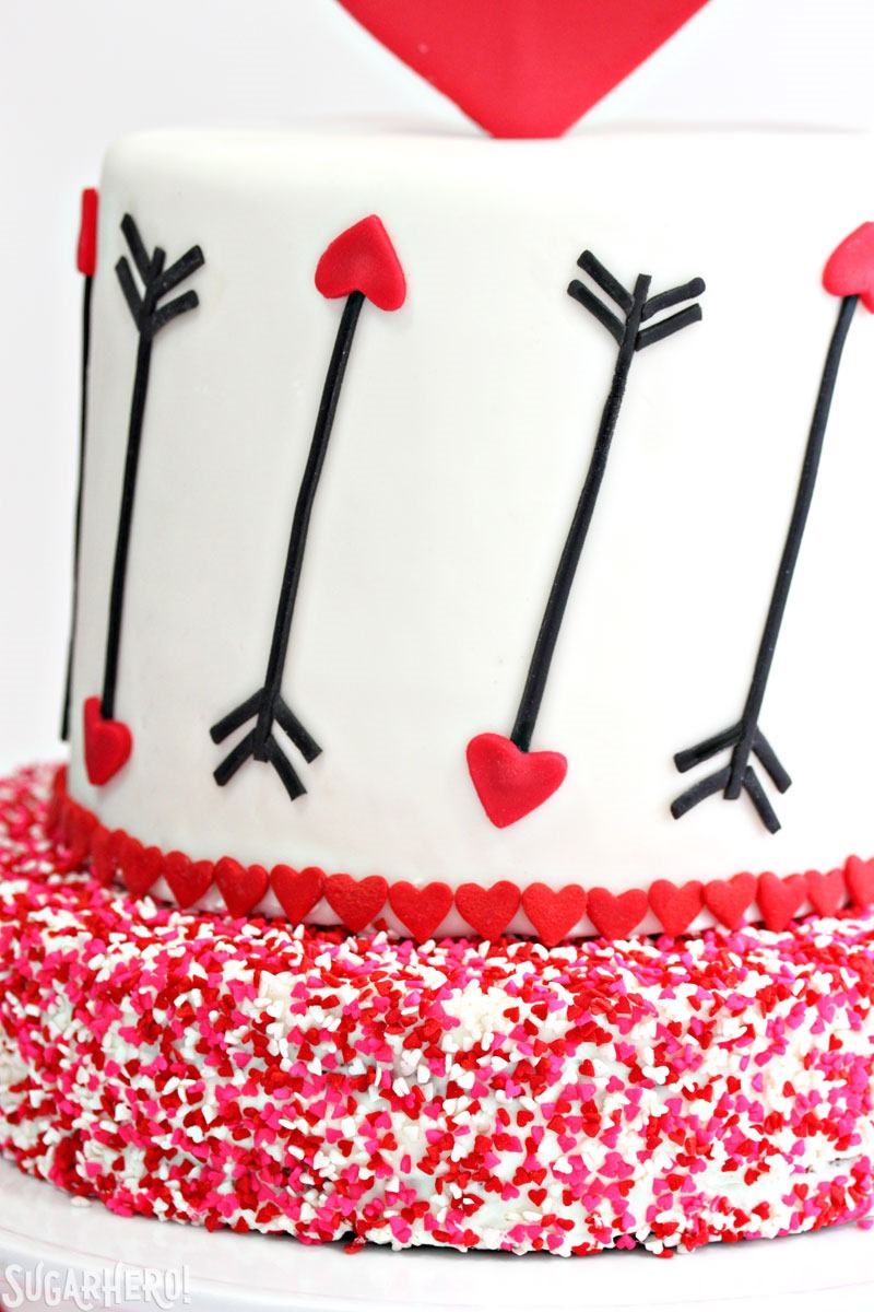 Pink and Red Velvet Valentine’s Day Cake - a pink and red velvet cake with a heart and arrow design for Valentine's Day! | From SugarHero.com