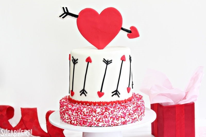 Pink and Red Velvet Valentine’s Day Cake - a pink and red velvet cake with a heart and arrow design for Valentine's Day! | From SugarHero.com