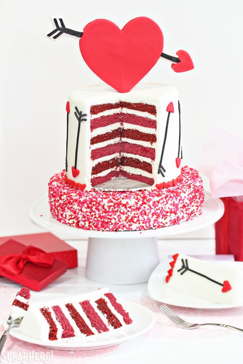 Pink and Red Velvet Valentine’s Day Cake - a pink and red velvet cake with a heart and arrow design for Valentine's Day! | From SugarHero.com