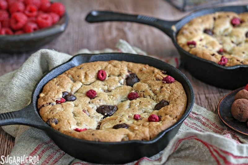 Raspberry Truffle Skillet Cookies - packed with gooey chocolate truffles, raspberries, and nuts! | From SugarHero.com